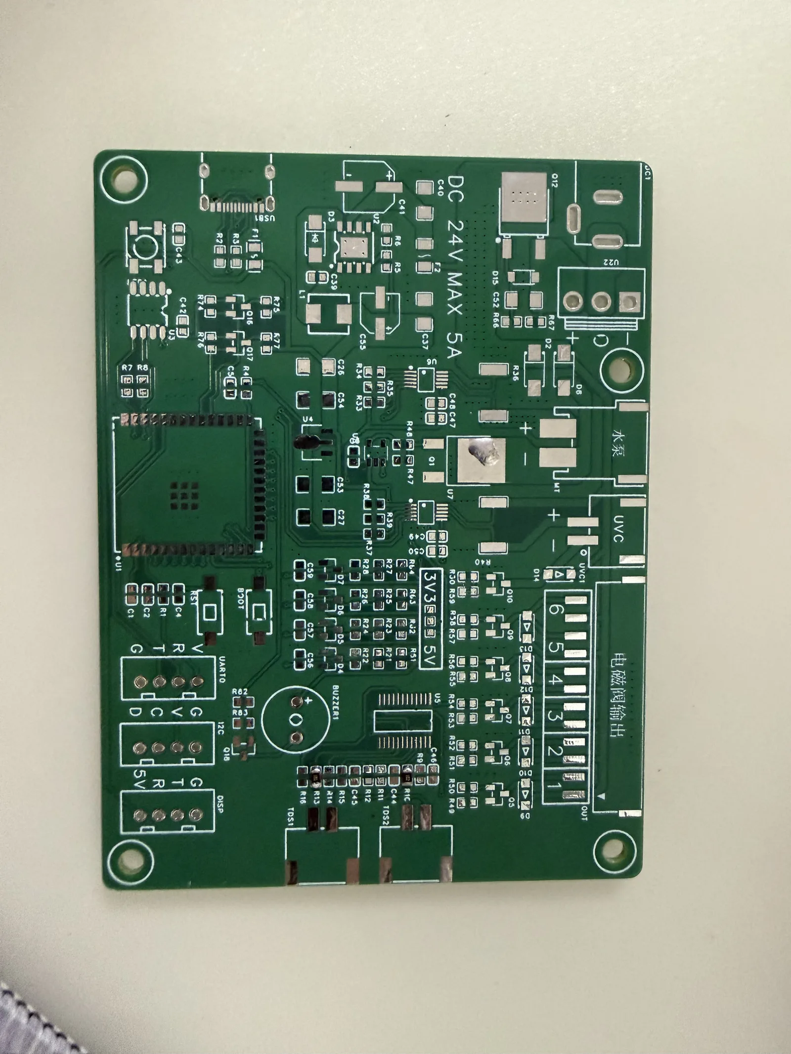 Green prototype RO controller PCB with component pads and labelled connections.